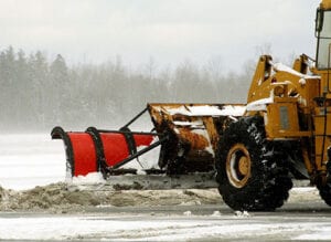 Clearing snow from site using bulldozer